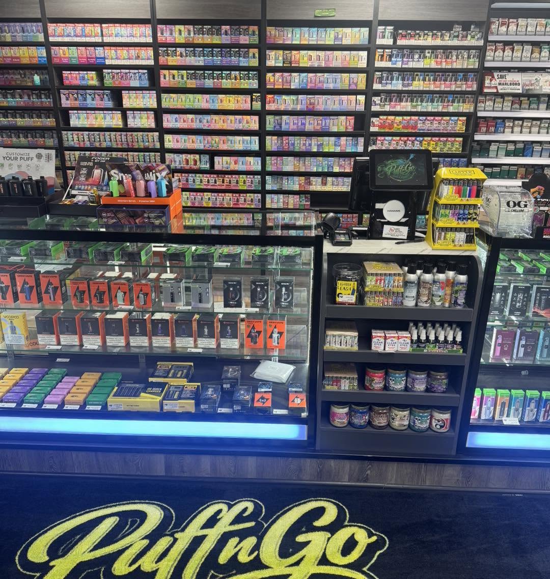 Floor-to-ceiling disposable vape wall at Puff n' Go